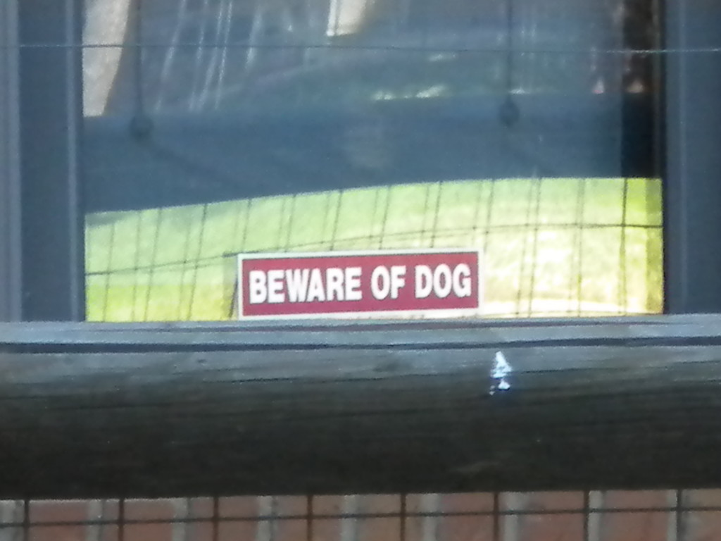 A very little Beware of Dog sign