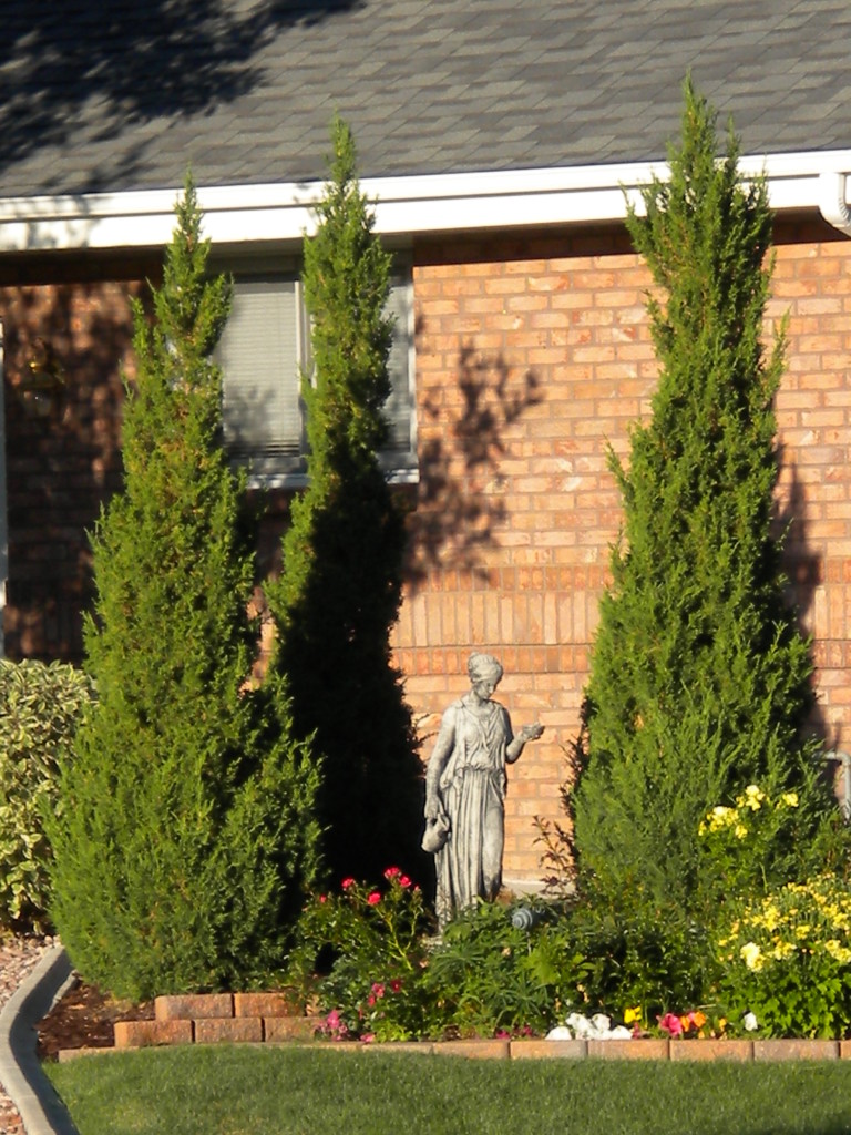 statue with 3 trees