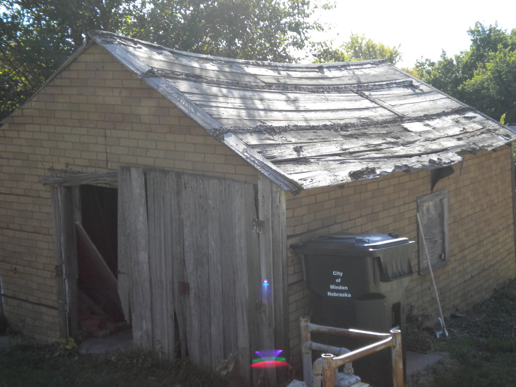old shed (with colorful camera glare at bottom middle of photo)